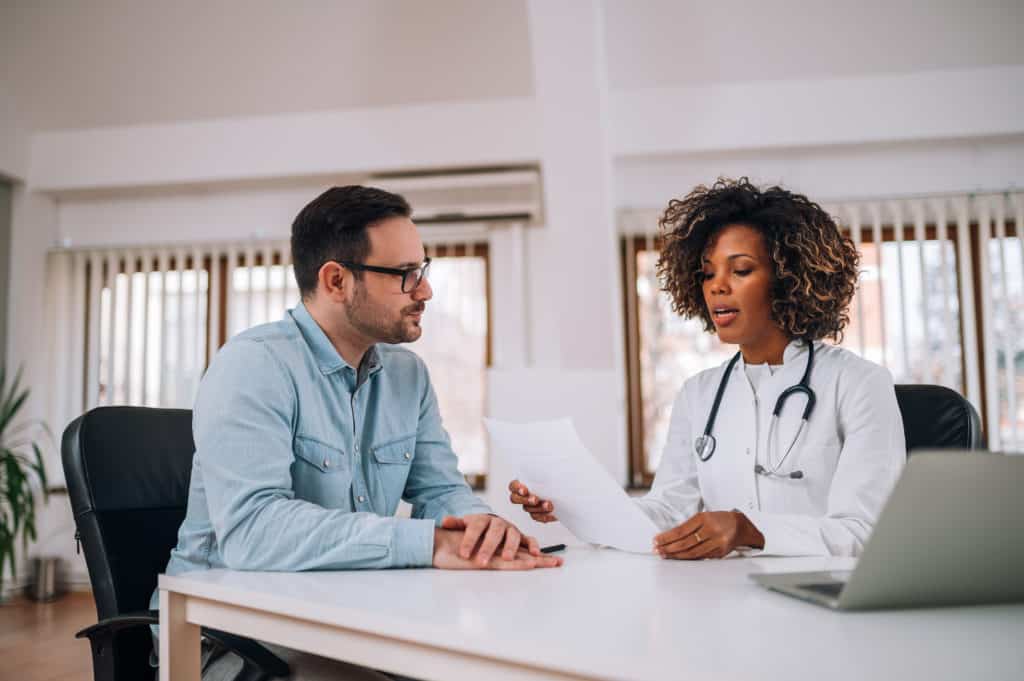 Doctor talking to a patient at medical clinic.