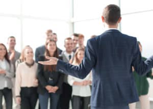 rear view. the young leader explaining something to his team. photo with copy space